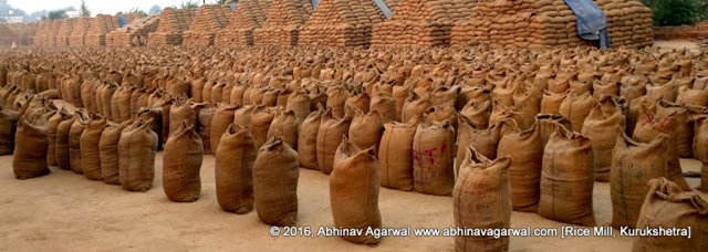 Gunny sacks with rice piled in the compound of a rice mill. 